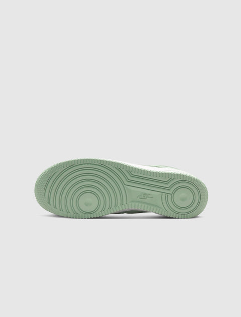 Light green Nike sneaker sole with circular tread pattern, streetwear footwear