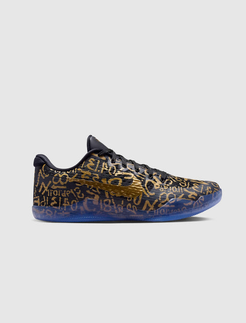 Black and gold low-top sneaker with metallic swoosh and abstract graphic pattern