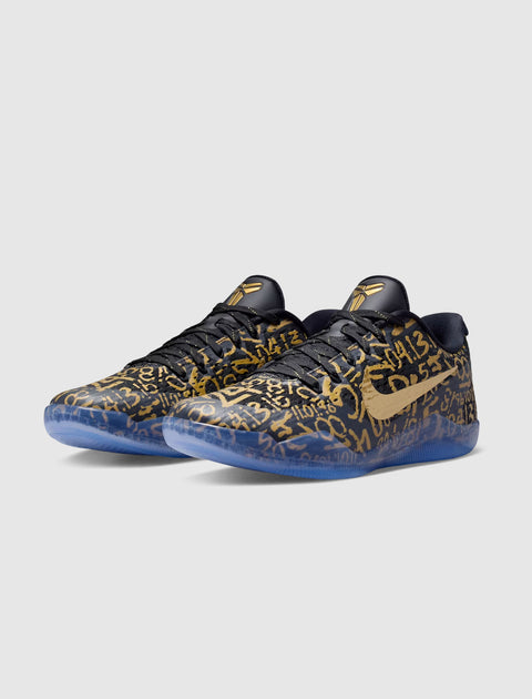 Black and gold low-top sneakers with graphic numbers, translucent blue sole, side Nike swoosh