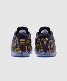 Rear view of black and gold patterned sneakers with translucent soles on a plain background
