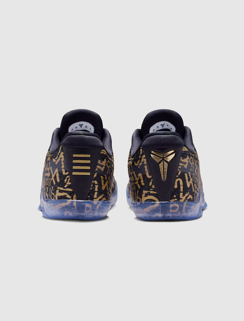 Rear view of black and gold patterned sneakers with translucent soles on a plain background