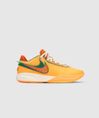 Orange and green low-top sneaker with textured side swoosh on a white sole