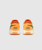 Orange and green low-top sneakers, back view, with A&M logo on heel, white soles
