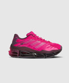 Bright magenta athletic sneaker with mesh upper and chunky black cushioned sole