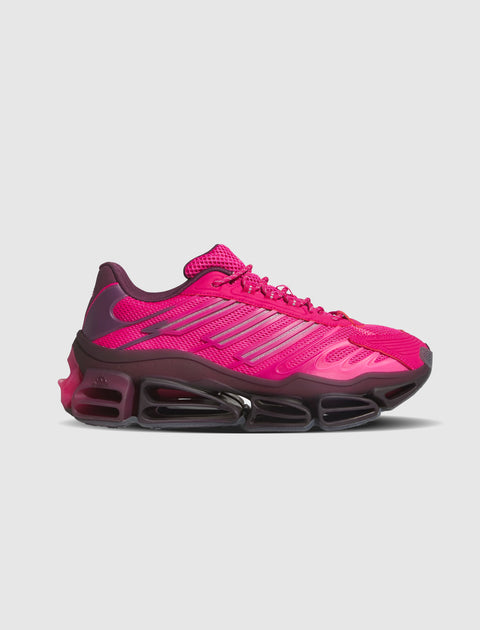 Bright magenta athletic sneaker with mesh upper and chunky black cushioned sole