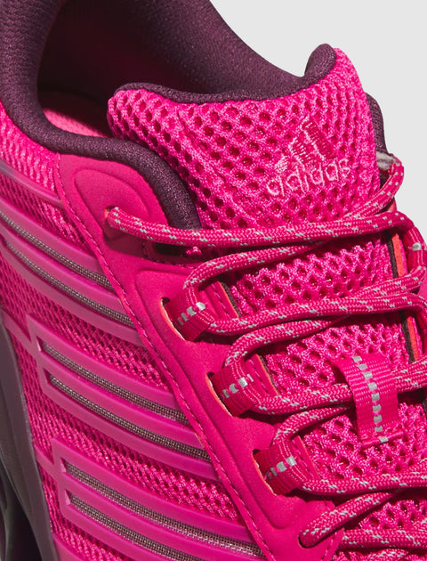 Close-up of vibrant magenta athletic sneaker with mesh upper and reflective laces