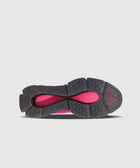 Black and magenta sneaker outsole with textured grip and circular tread pattern