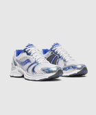 White and blue mesh sneakers with metallic silver accents and chunky soles on a plain background