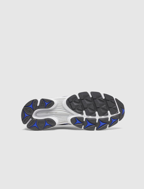 Black and blue athletic sneaker sole with textured grip on white background