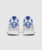 Back view of white and blue mesh athletic sneakers with chunky sole on light background
