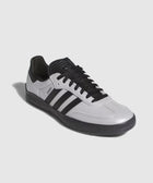 Low-top white and black leather sneaker with black laces and three side stripes