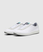 White low-top sneakers with grey accents, perforated sides, and textured soles