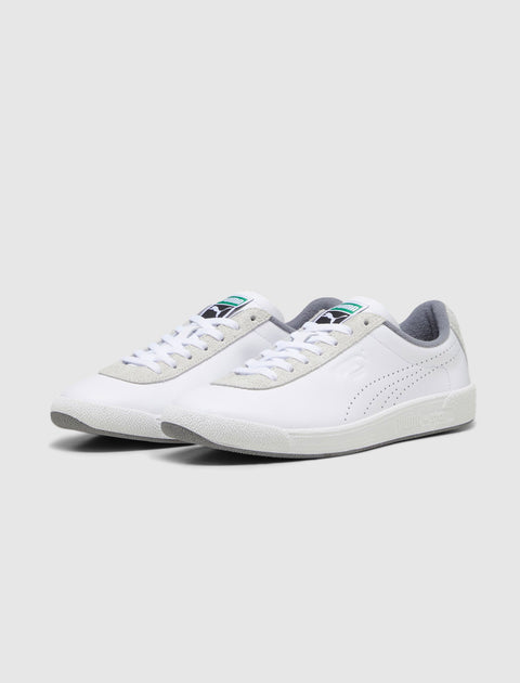 White low-top sneakers with grey accents, perforated sides, and textured soles