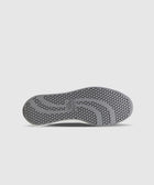 Gray sneaker sole with honeycomb traction pattern on white background