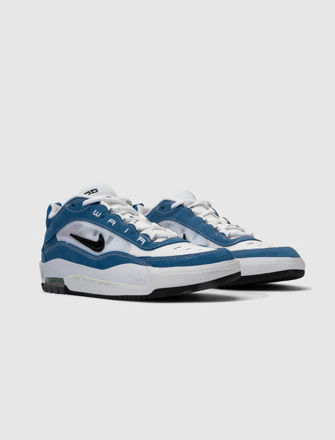 Blue and white Nike Air sneakers with black swoosh, white laces, and visible Air unit