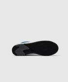 Sole view of a white and blue streetwear sneaker with black tread pattern