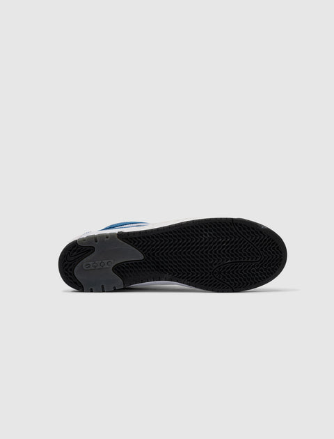 Sole view of a white and blue streetwear sneaker with black tread pattern