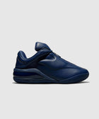 Dark navy blue low-top sneaker with smooth leather upper, side profile on white background