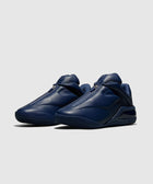 Men's navy blue leather sneakers with zipper closure and chunky sole on white background
