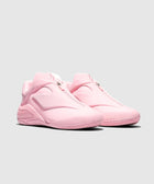 Pair of light pink slip-on sneakers with a sleek, modern design on a plain background