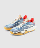 Blue patterned low-top sneakers with cream laces, red lining, and gum soles on a gray background