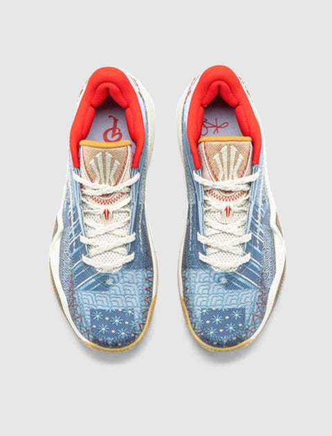 Blue patterned men's sneakers with white laces, orange lining, gum sole, top view