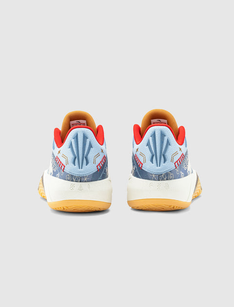 Light blue patterned sneakers with red accents and gum soles, rear view on white background