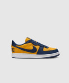 Low-top sneaker in yellow and navy leather with white sole, side profile on plain background