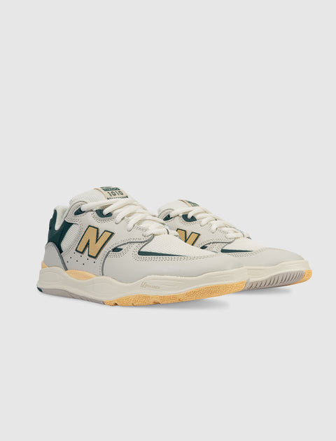Men's beige and green sneakers with yellow accents and chunky sole on white background
