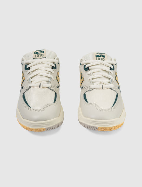 Front view of white and green sneakers with TIAGO 1010 label, mesh and suede details