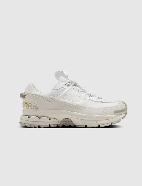 All-white men's streetwear sneaker with textured sole and layered design on clean background