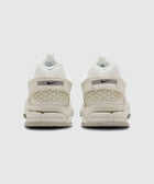 Rear view of white Nike Zoom sneakers with textured heel and light grey outsole on white background